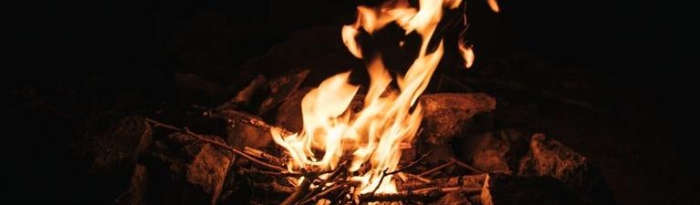 Log fire burning in dark fireplace