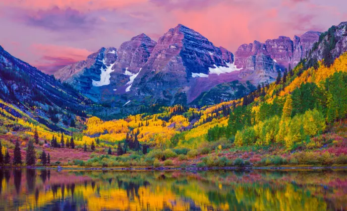 Colorful autumn photo of Maroon Bells from the lake. 