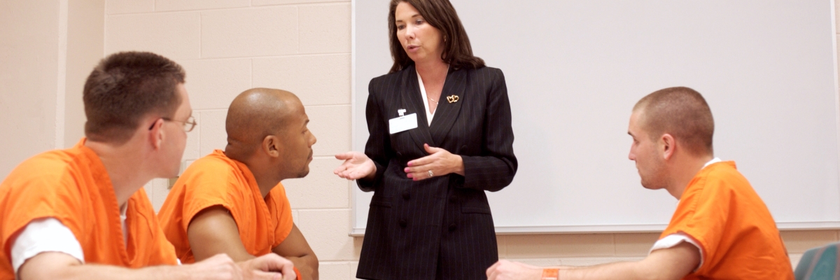 Incarcerated men in a classroom listening to presenter