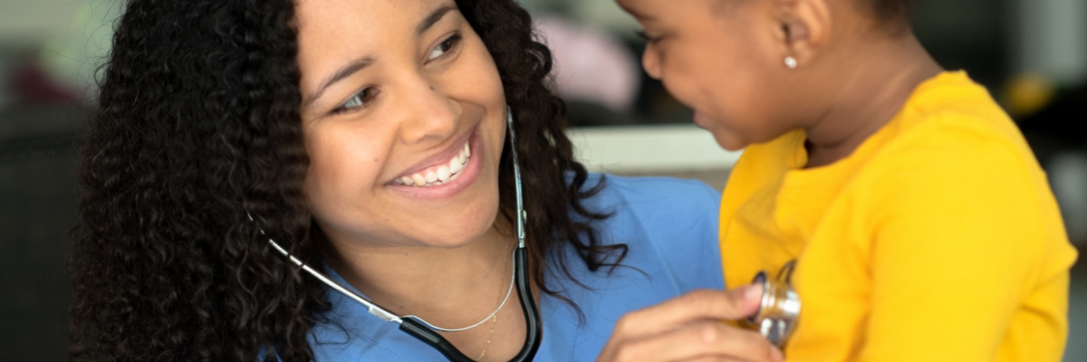 Nurse uses a stethoscope on a child