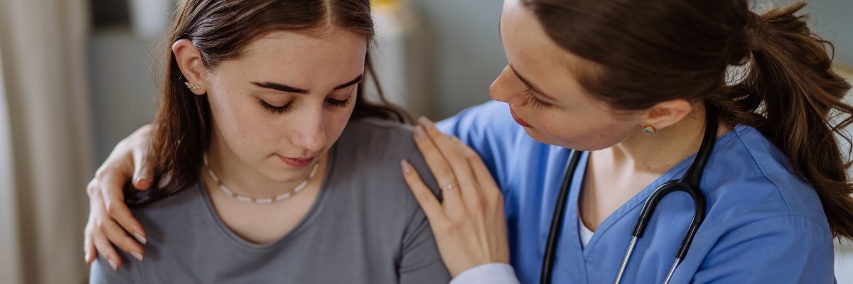 Nurse comforting a teen