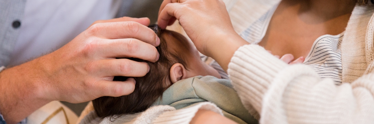 Newborn snuggles with parents