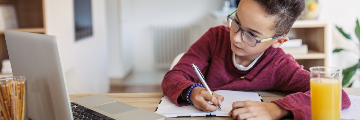 Young child does homework on laptop