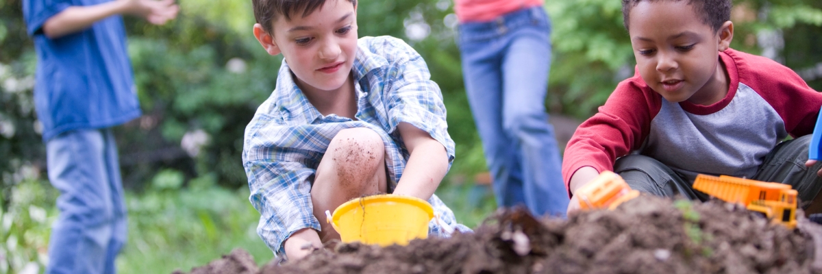 Kids play with colorful toys in the dirt