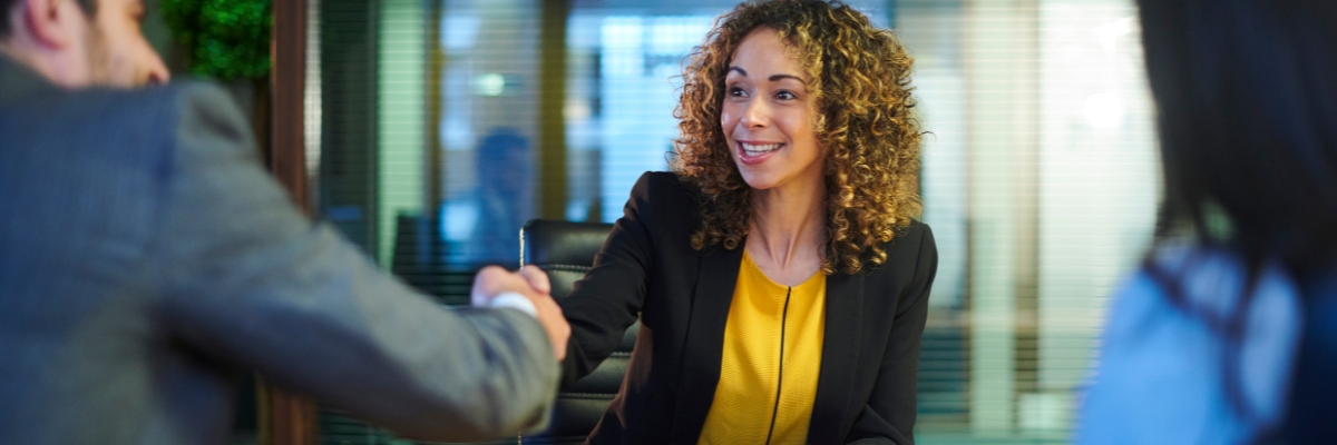 Black woman shakes hand of job interviewer
