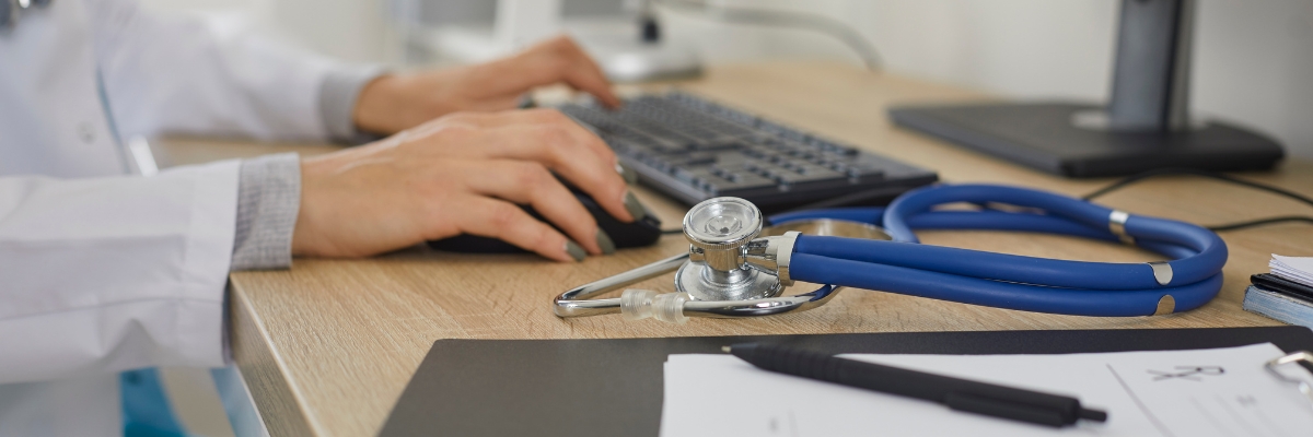 Stethoscope and paperwork on doctor's desk