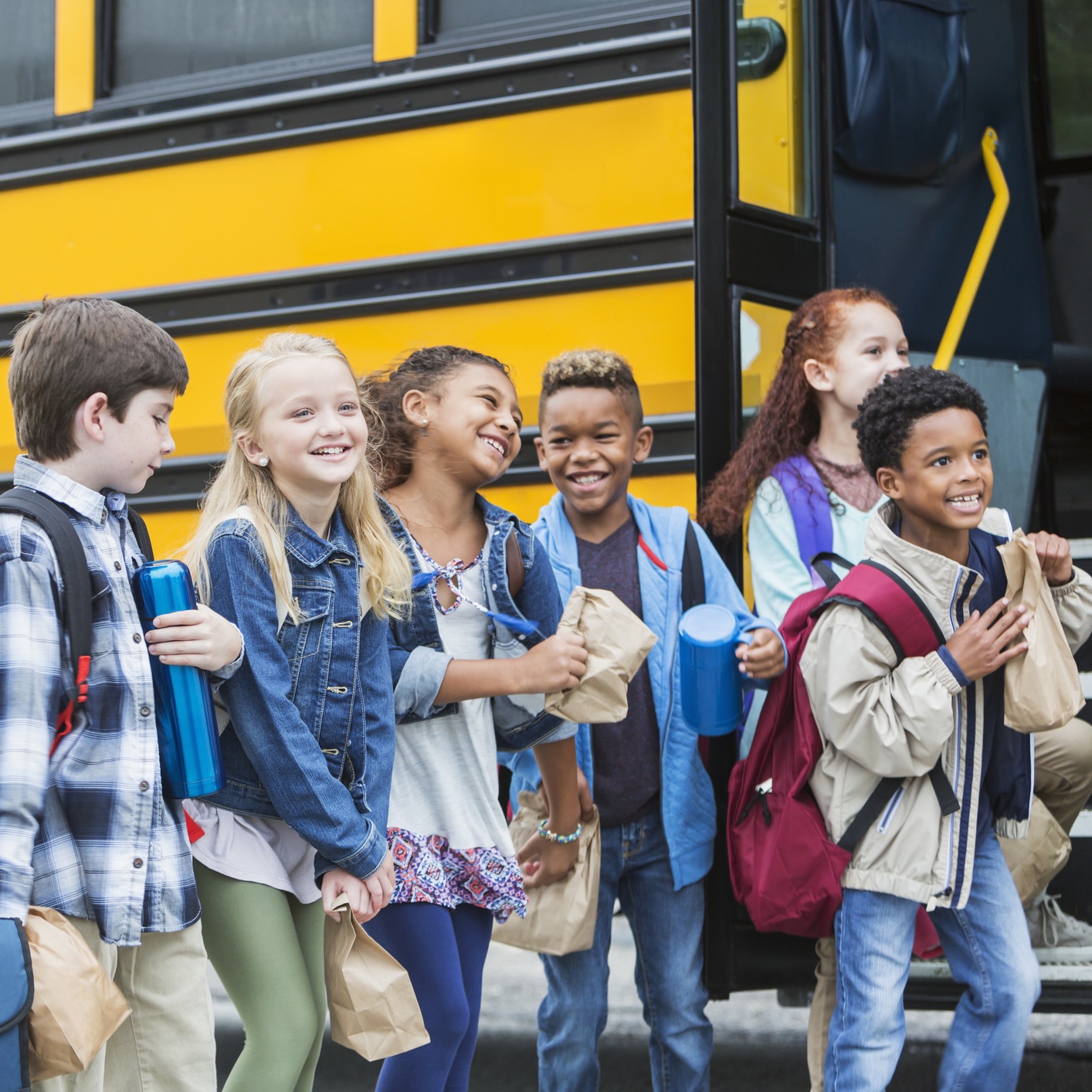 kids getting on school bus