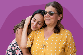 An older woman embraces a younger woman