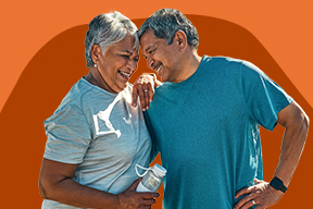 An older man and an older woman lean on one another.