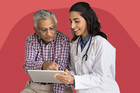 A female health professional goes over a chart with an older man.