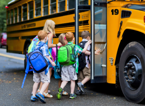 A group of students board a school bus.