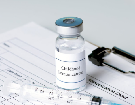 A vial of vaccine is shown with a syringe and a chart underneath.