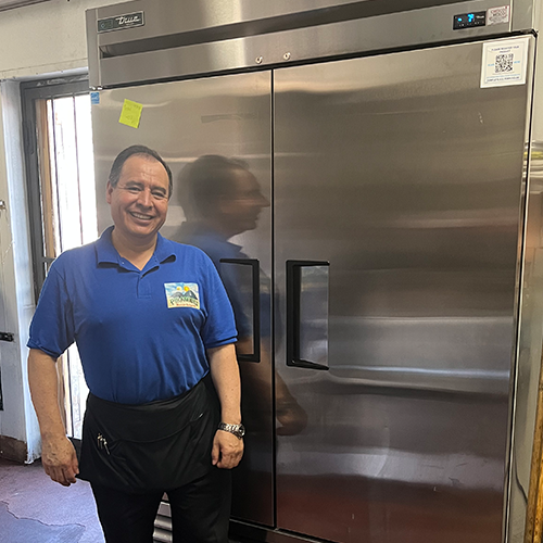 Piramides owner pictured with their new efficient refrigeration equipment.