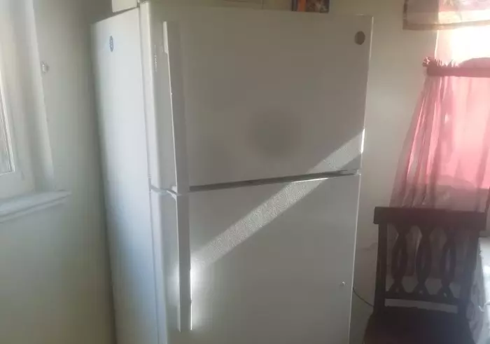 White refrigerator in a house