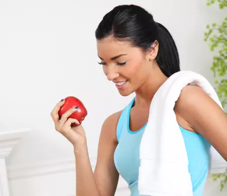 Woman exercising with apple