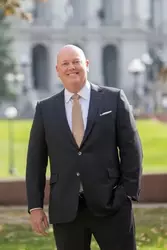 Christopher Howes, bald white male in a suit