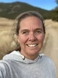 Smiling woman outdoor on a dirt trail