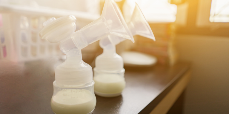 Image of two breast pumps with milk