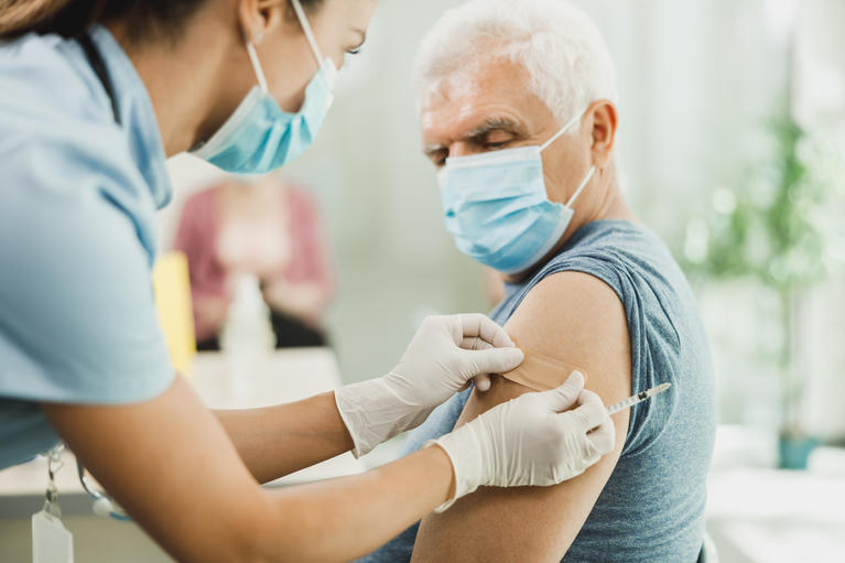 Senior male gets vaccine