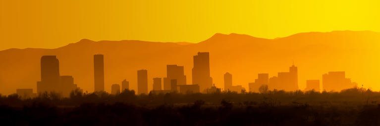 Denver skyline at sunset, sky is orange