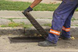 City worker opening stormwater drain