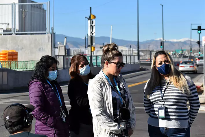 Hispanic Women speaking for Colorado Public Radio during Elyria-Swanson walking tour