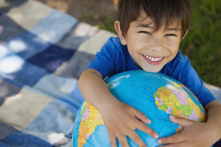Child holding a globe