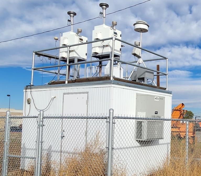 Colorado Air Toxics Trends Station (COATTS) monitoring site; a small building with samplers visible on the roof, located in a field
