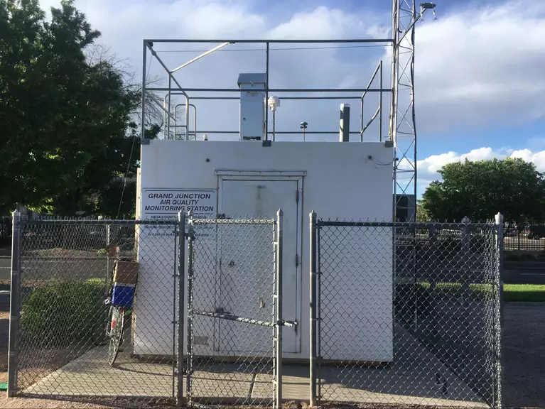 National Air Toxics Trends Station (NATTS) monitoring site; includes a small, fenced-in building with a sampler visible on the roof