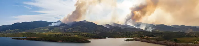 Panoramic view of a wildfire burning through Colorado mountains