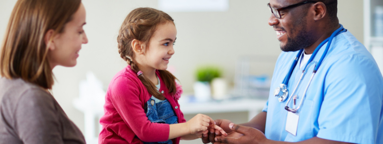 Provider talking with child patient and parent