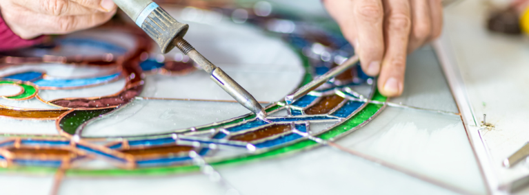 Stained glass artist working with lead