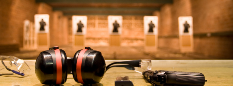 Indoor shooting range with safety glasses, ear protection and gun